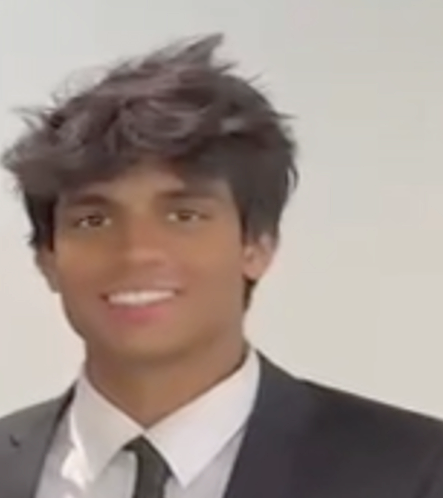 Ketav Karthikeyan in a black tie and black suit.